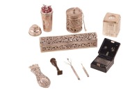 A group of silver items comprising a silver page turner handle (ivory blade, removed), matchstick holder, table-top cigar cutter, pierced silver string box, dome-topped Eastern betel leaf (?) box with pierced detail, telescopic "swizzle stick" and telesco