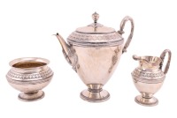 A German Art Deco (800) white metal three-piece "Etruscan" teaset, second quarter of the 20th century, of inverted urn form with raised silver gilt diamond bands, each fitted with high arched leaf-capped handles on beaded spreading disk feet. 29.25 ozt/91